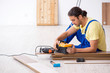 © Elnur - Young male contractor working indoors