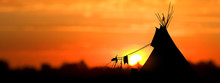 An American Indian Tipi (teepee) Against An Evening Sunset.