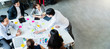 © whyframeshot - Happy businessman teamwork brainstorm and discussing on white table during business presentation in the office.