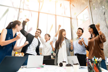 Multi-ethnic businesspeople cheering with business project successful in meeting room office backgroound