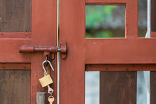 Red Grunge Vintage Steel And Wood Door Secure With Yellow Lock With Key