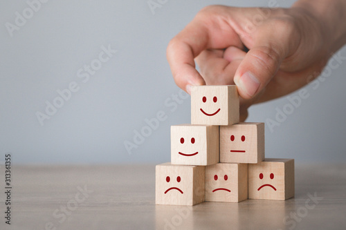 Cuadros en Lienzo Customer pressing smiley face emoticon on wood cube, Service rating, satisfaction concept