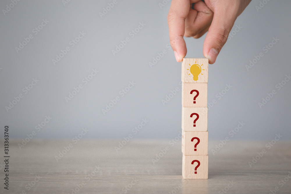 Hand arranging wood block stacking with icon question mark and lamp ...