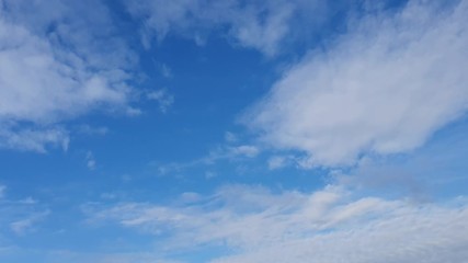 white clouds disappear in the hot sun on blue sky. 4k motion clouds, blue sky background and sun