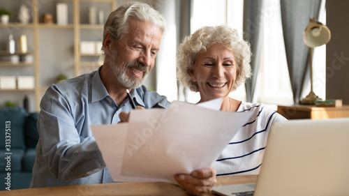 Cuadros en Lienzo Senior couple use online banking on laptop planning family budget