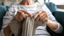Close Up View Grandmothers Hands Holding Needles And Knitting