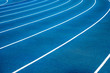 © LOVEis - Blue running treadmill track with lane numbers in stadium outdoors.Starting grid of race track at the stadium
