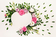 Valentine's day romantic concept. Creative floral heart made of white and pink roses and green leaves