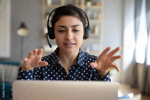 Cuadros en Lienzo Indian woman teacher wear wireless headset video calling on laptop
