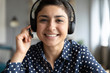 Smiling indian girl professional wear headset look at camera webcam