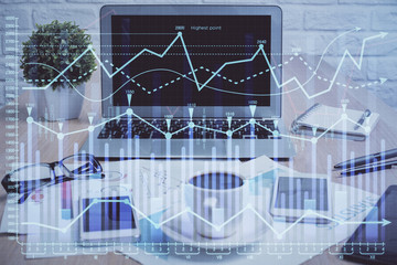 Forex market graph hologram and personal computer on background. Double exposure. Concept of investment.