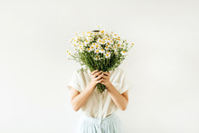 Young Pretty Woman With Bouquet Of White Chamomile Daisy Flowers On White Background.