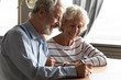© fizkes - Satisfied senior couple signing agreement buying medical health insurance