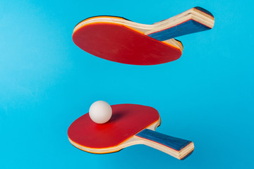 Wall Mural - Red ping pong racket on a blue background