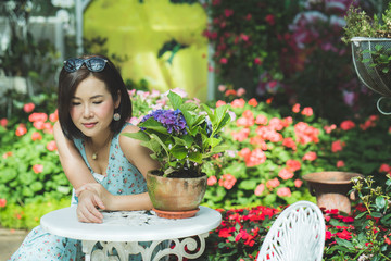 Wall Mural - Beautiful asian women sitting at table in garden.