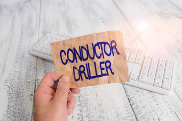 Poster - Writing note showing Conductor Driller. Business concept for means of conveying the upflowing drilling fluid Man holding colorful reminder square shaped paper wood floor
