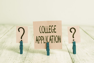 Poster - Text sign showing College Application. Business photo showcasing individuals apply to gain entry into a college Scribbled and crumbling sheet with paper clips placed on the wooden table
