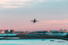 Airplane Taking Off From London City Airport At Sunset