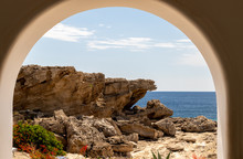 View Out Of An Archway On The Rocky Coastline At Kallithea Therms, Kallithea Spring On Rhodes Island, Greece