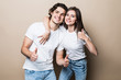 © F8  \ Suport Ukraine - Portrait of beautiful people man and woman in basic clothing posing together at camera with thumbs up isolated over beige background