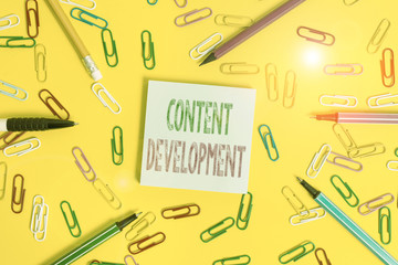Fototapete - Handwriting text writing Content Development. Conceptual photo Authoring and originating content for any medium Flat lay above empty paper with copy space pencils and colored paper clips