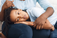 Black Daughter Lying Her Head On Mom's Lap