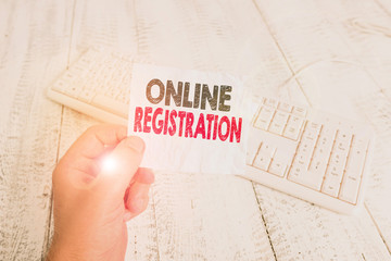 Poster - Writing note showing Online Registration. Business concept for registering via the Internet as a user of a product Man holding colorful reminder square shaped paper wood floor