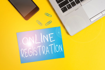 Poster - Text sign showing Online Registration. Business photo showcasing registering via the Internet as a user of a product Trendy open laptop smartphone small paper sheet clips colored background