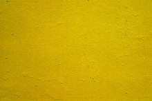 Beautiful Textured Plaster On The Wall. Yellow Green Abstract Background. Beautiful Yellow Textured Stucco On The Wall. Background From Yellow-green Stucco.