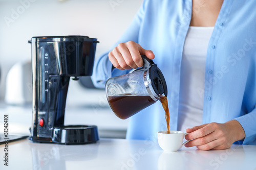 Cuadros en Lienzo Woman using coffee maker for making and brewing coffee at home