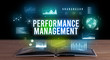 © ra2 studio - PERFORMANCE MANAGEMENT inscription coming out from an open book, creative business concept