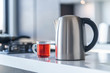 Electric kettle for boiling water and making tea on a table in the kitchen interior. Household kitchen appliances for makes hot drinks