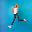 © Prostock-studio - Wow! Excited woman jumping and using phone