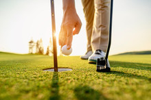 Lifestyle, Golf, Activity, Outdoor, Sport, Golfer Concept. Golfers Collect Golf Balls That Hole In The Green Grass On The Golf Course In The Morning.