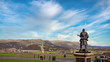 The statue of a kilted soldier in the front, King Robert de Bruce's in the Middle and the Wallace Monument at the distance.
