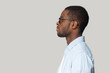 © fizkes - African man isolated on gray background side profile view face