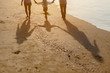 © Garun Studios - Family, travel, beach, relax, lifestyle, holiday concept. Family who enjoy a picnic. Parents are holding hands their children and walking on the beach at sunset in holiday.