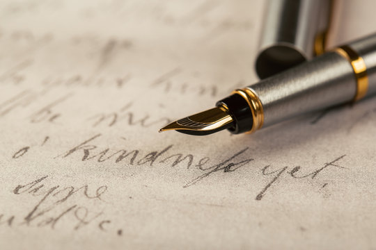Fountain pen on an ancient handwritten letter. Old story. Retro style.