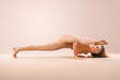 © Mike Orlov - Indoor Yoga Classes. Sports recreation. Beautiful young woman in asana pose. Individual sports. Nude sportswear.