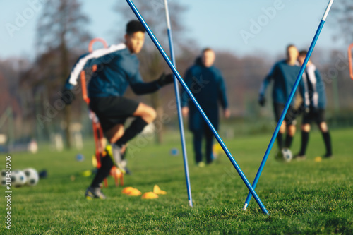 Football soccer training session for junior level athletes. Boys football tra...