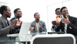 © ASDF - business team applauds sitting at the office Desk