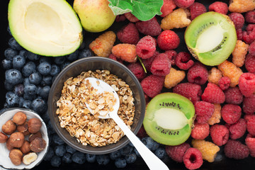 Wall Mural - Ingredients for a healthy breakfast. Nutrition, granola, oatmeal, nuts, fruits, berries, kiwi, bananas, raspberries, blueberries, seeds, apples. A diet rich in vitamins and fiber. Top view.