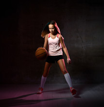 Teenage Girl Dribbling Basketball