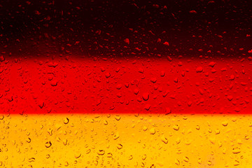 Wall Mural - Flag of Germany. Drops of water on a glass of beer. Light and dark beer. Background, Texture