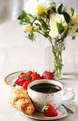 Wall Mural - Breakfast. Croissant and strawberry. And black coffee, a bouquet of flowers. Fresh strawberries. 