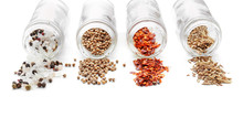 Bottles With Different Spices On White Background