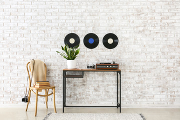 Canvas Print - Record player with vinyl disc on table in interior of room