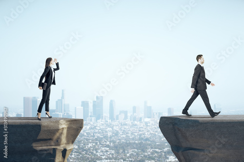 Businesswoman looking on businessman standing on mountain. Poster Mural XXL
