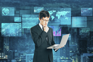 Wall Mural - Businessman with laptop and glowing business interface