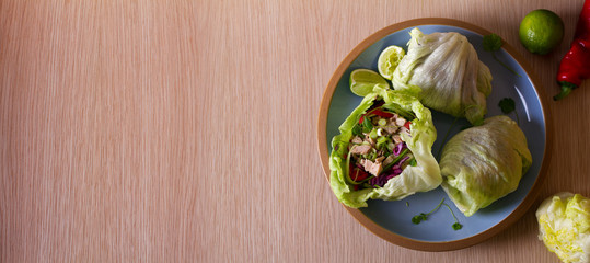 Stuffed iceberg lettuce cabbage leaves with chicken and vegetables. Wraps pockets of lettuce with chicken